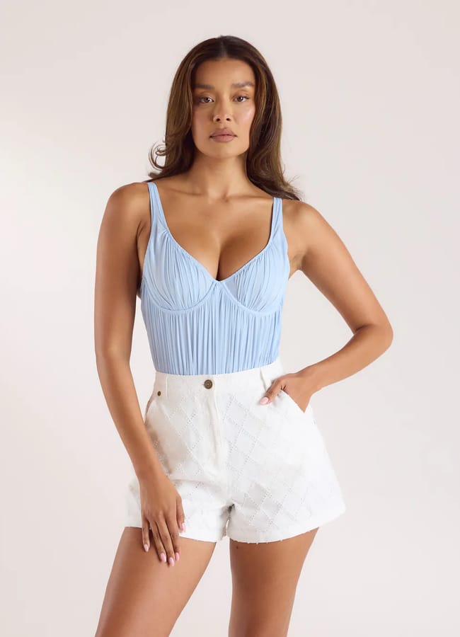 model wearing blue Pleated Mesh Bodysuit and white shorts