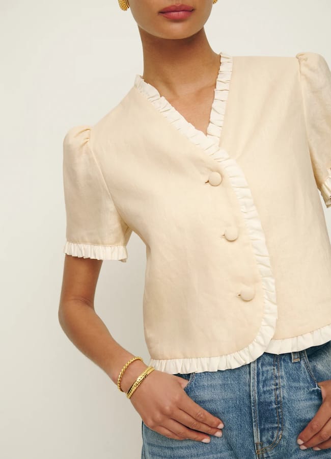 model close up wearing Bess Linen Top in yellow with buttons
