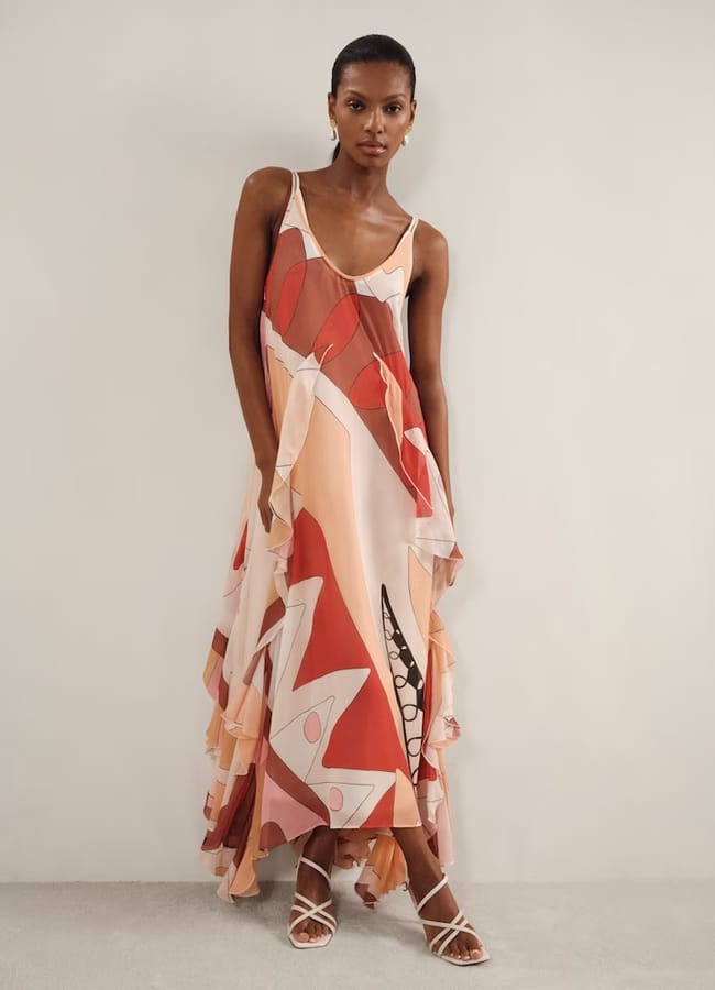 model wearing Sasha Printed Ruffle Trim Maxi Dress in Cream/Red