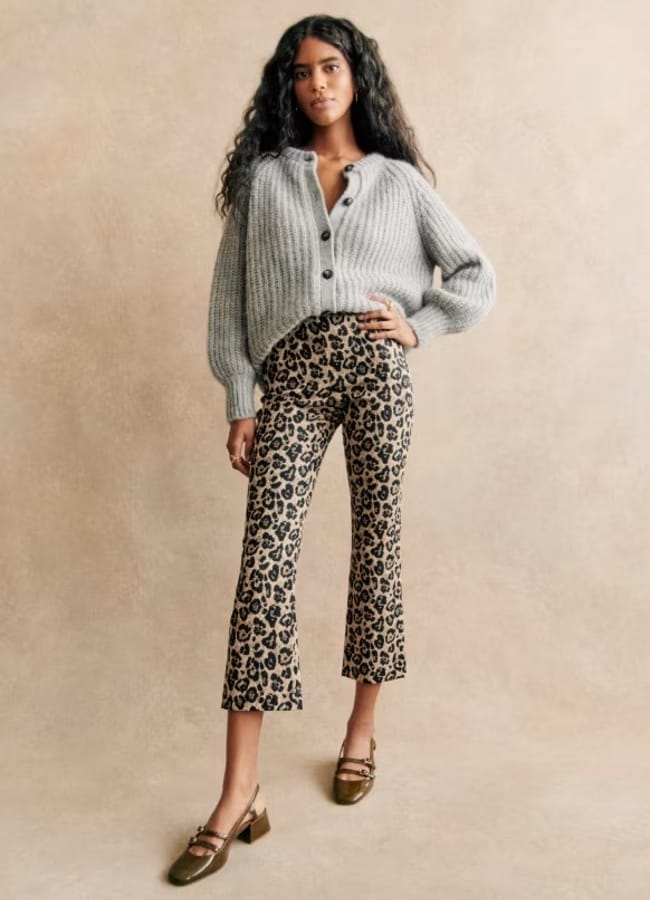 model wearing leopard trousers and grey knit