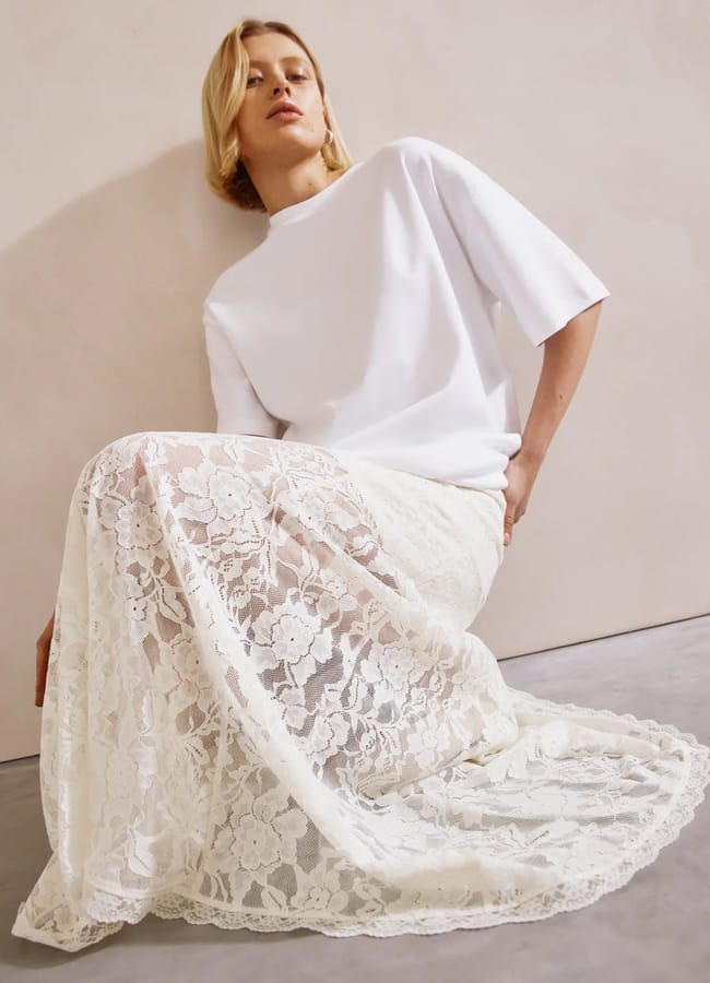 model wearing white t-shirt and white lace skirt