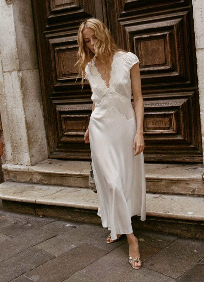 model wearing lace white dress in street