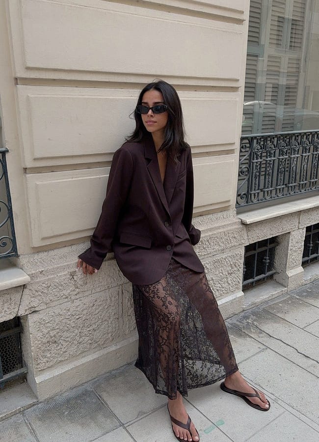 model on street wearing brown shirt and lace maxi skirt