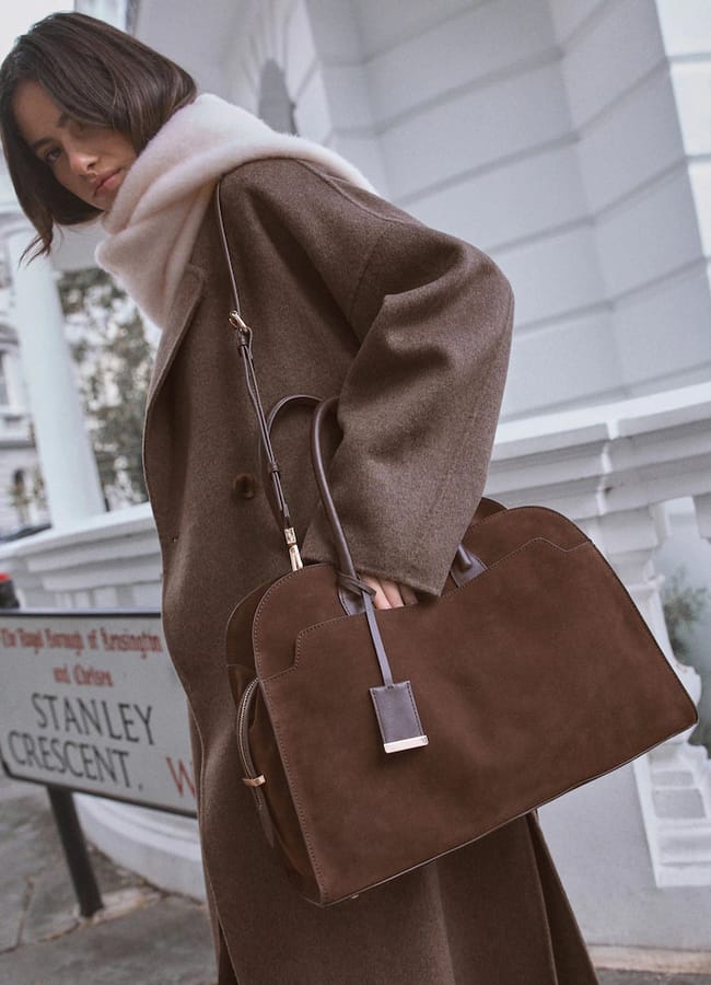 model wearing coat and scarf and carrying next Chocolate Brown Leather Premium Grab Bag