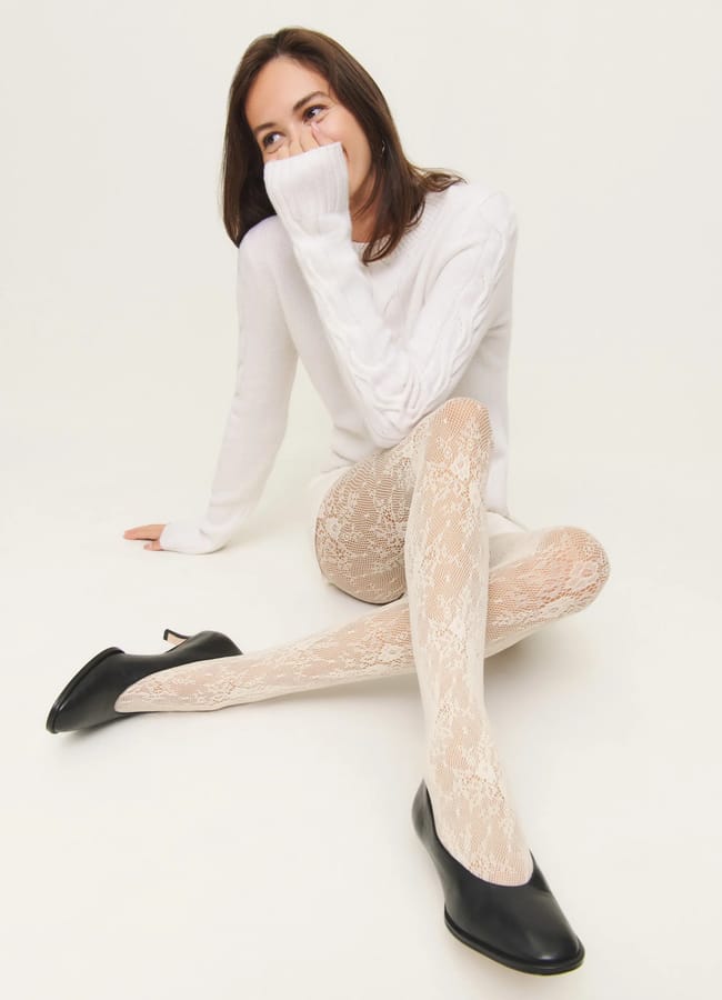 model wearing white top and white lace tights