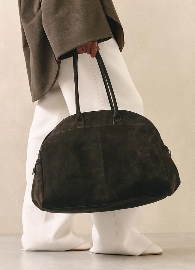close up of model holding bowling bag
