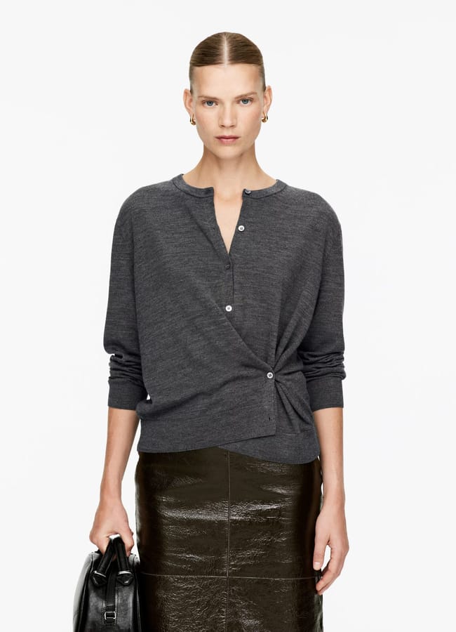 model wearing twisted Arket Merino Wool Cardigan