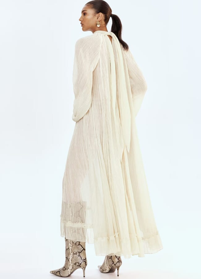 model wearing white bow collar dress