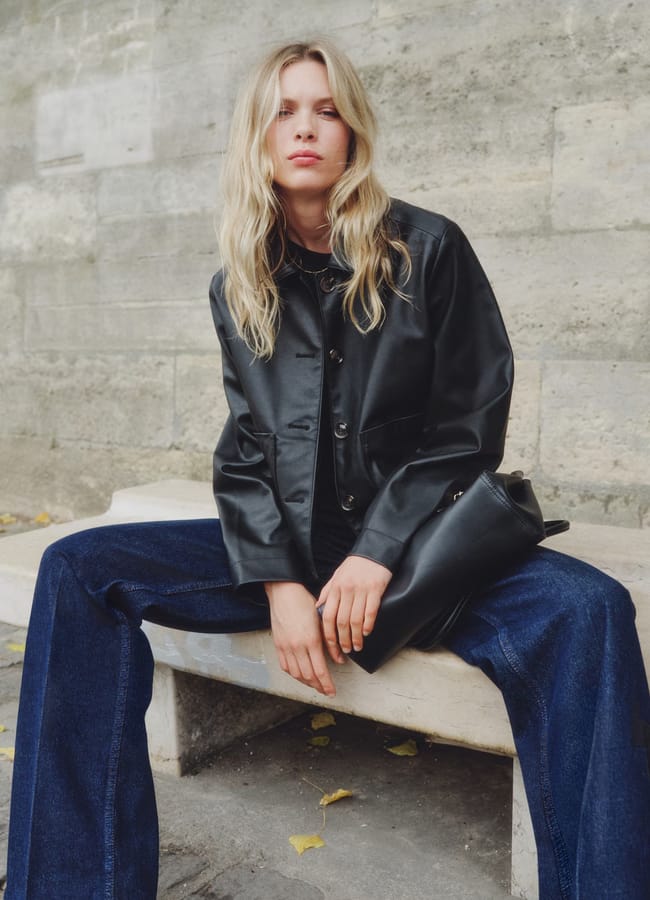MODEL WEARING BLACK H&M Coated jacket AND JEANS