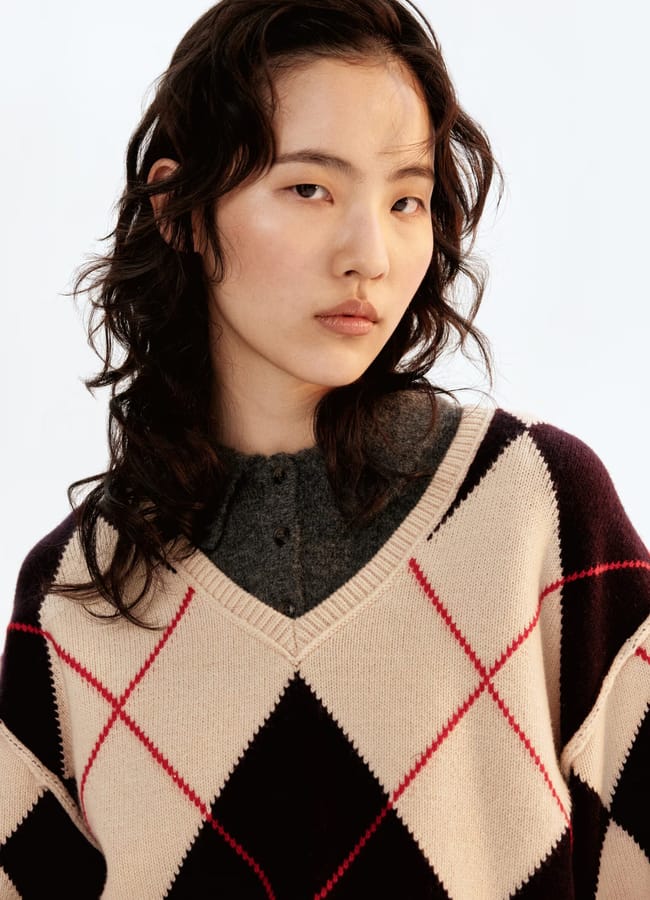 close up of model wearing beige argyle knit jumper