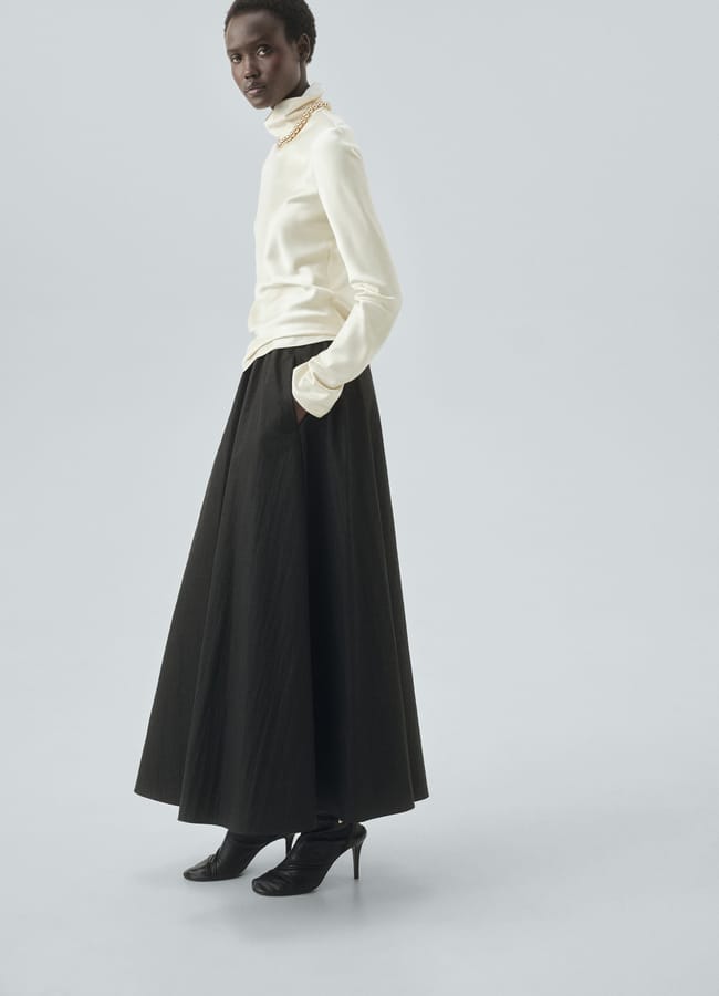 model wearing black flared skirt