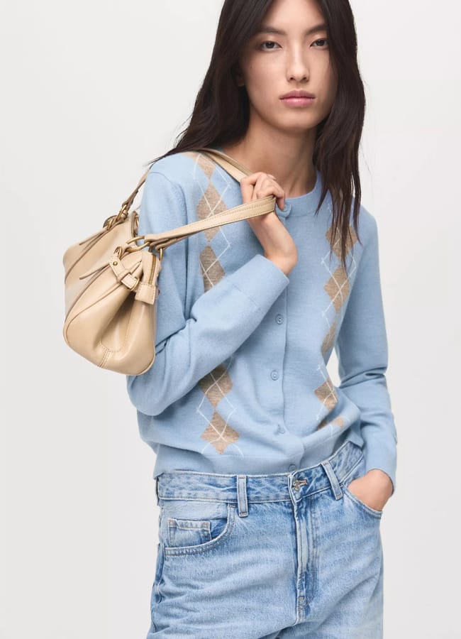 woman wearing blue argyle print cardigan