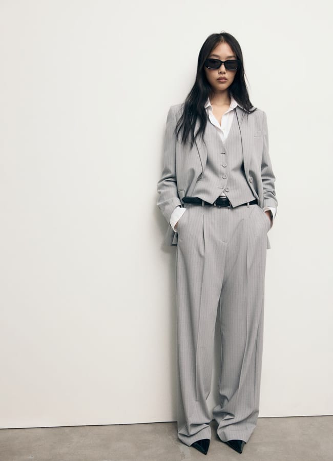 model wearing grey pinstripe suit