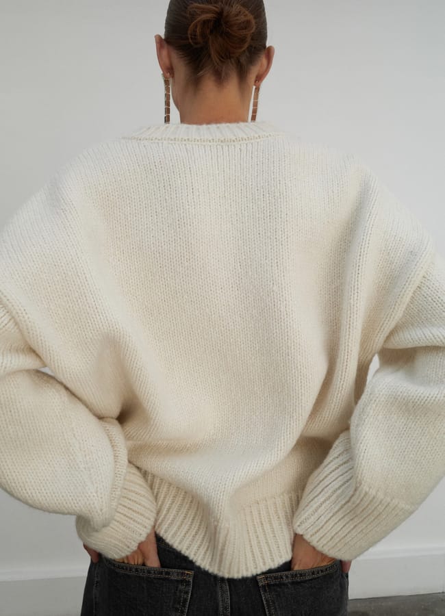 model from back wearing mango V-neck wool sweater