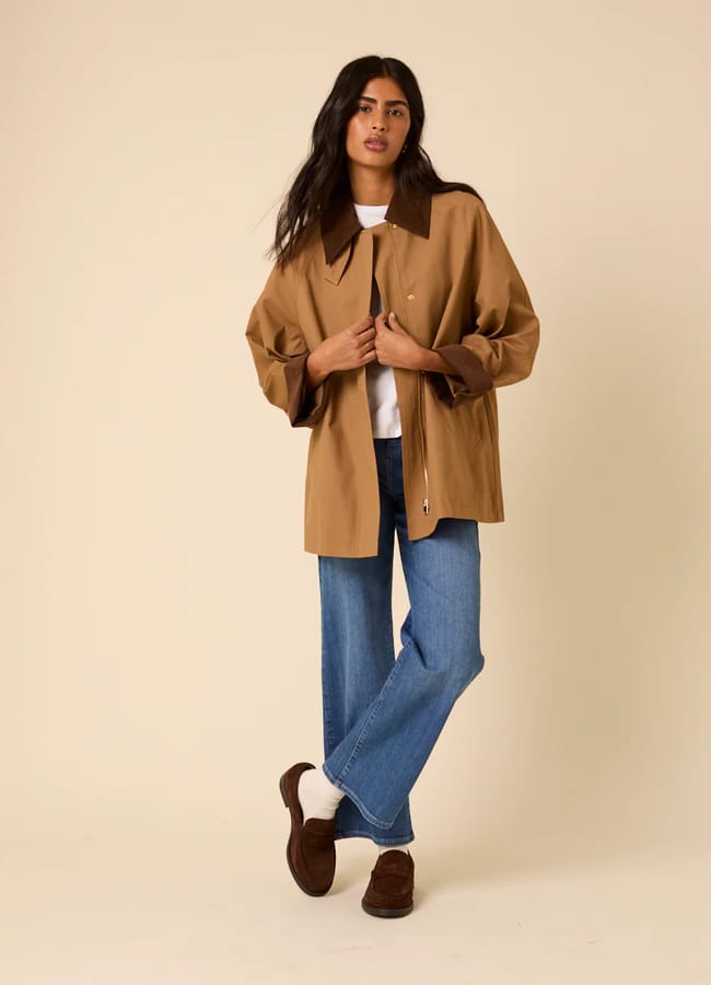 model wearing NC Camel Barn Coat and jeans