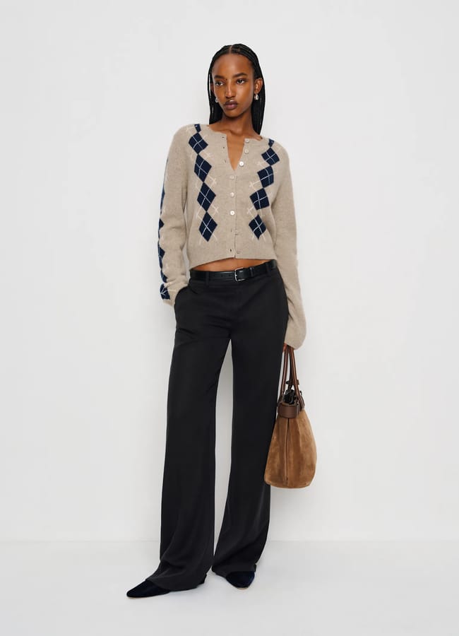 model wearing beige Reformation Clara Cashmere Crew Cardigan and black trousers