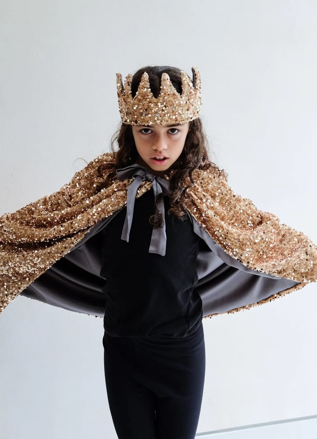 little girl wearing ml Sequin cape nand crown