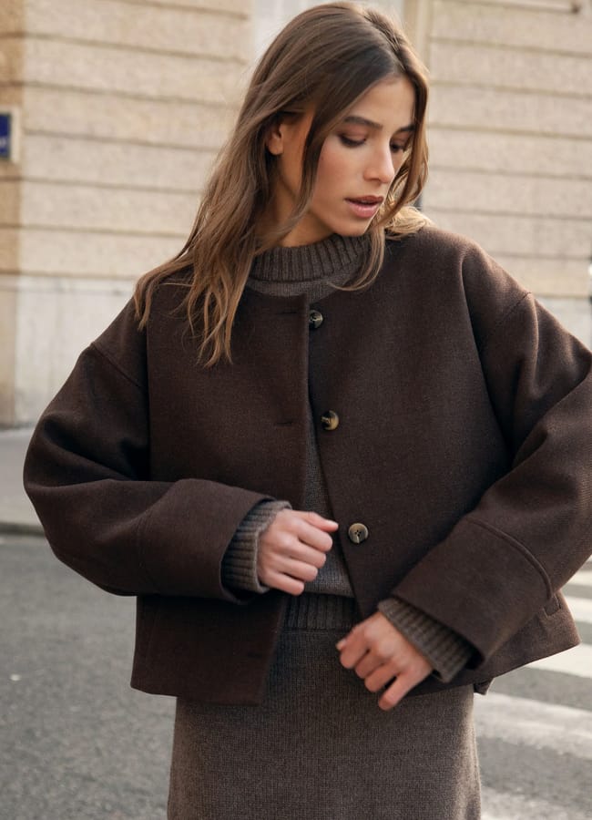 model wearing brown cardigan and skirt
