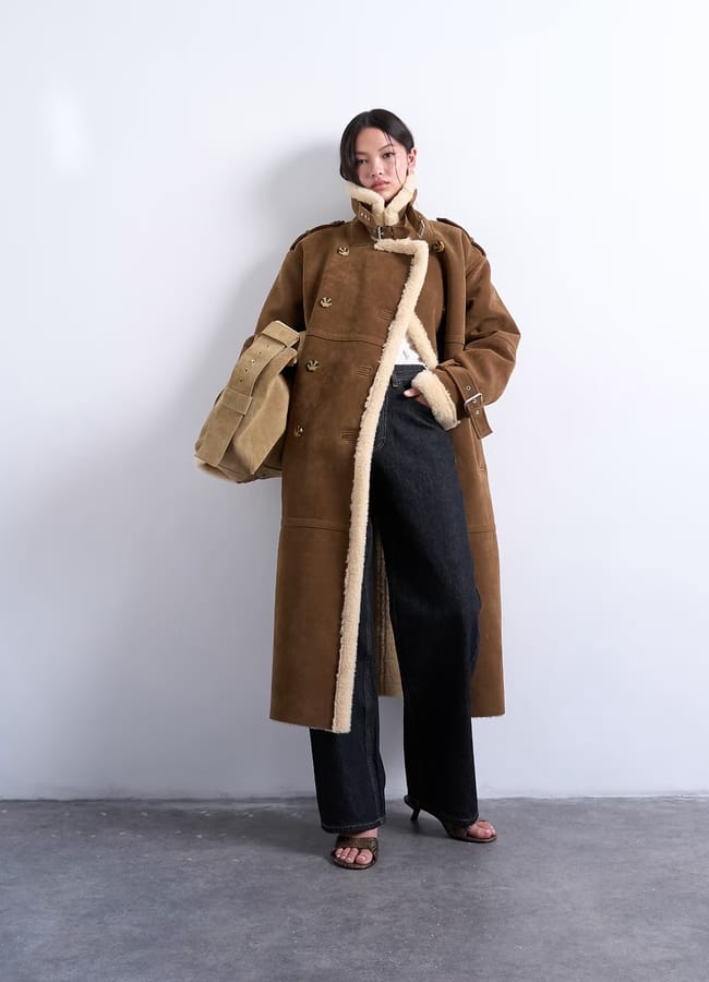 model weearing topshop Longline aviator shearling in tan cream in tan and cream