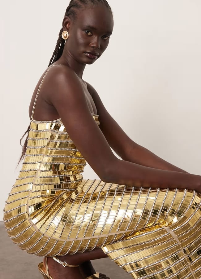 model crouching wearing ARRANGE linear encrusted column cami maxi dress in gold