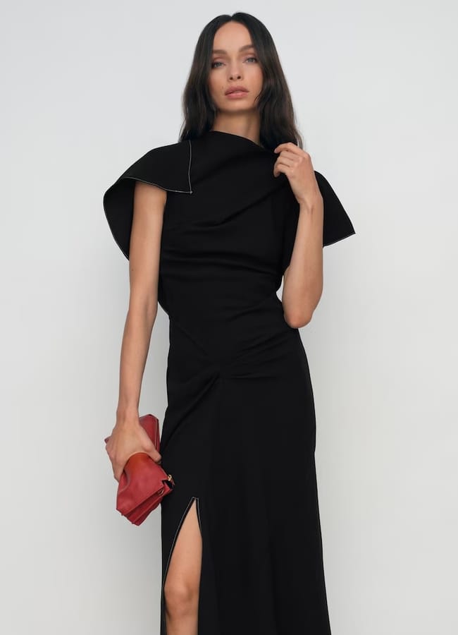 model wearing Saskia Asymmetric Draped Midi Dress in Black