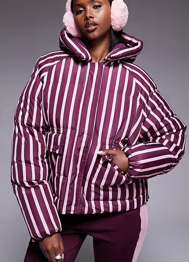 model wearing Threadbare Ski stripe puffer coat with hood in burgundy and pink