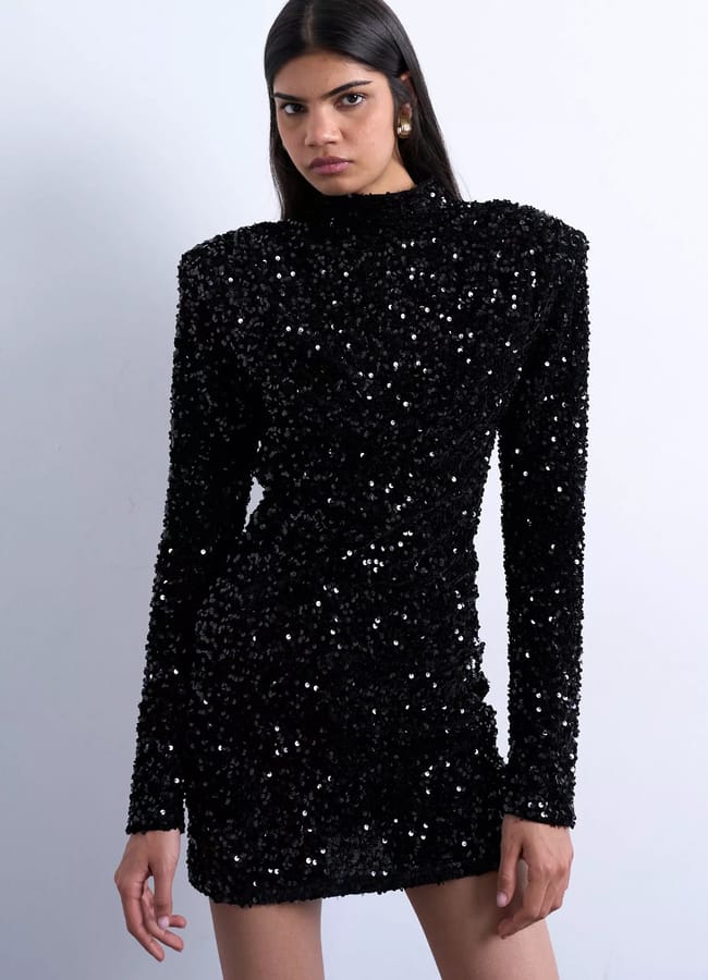 model wearing velvet sequin mini dress in black