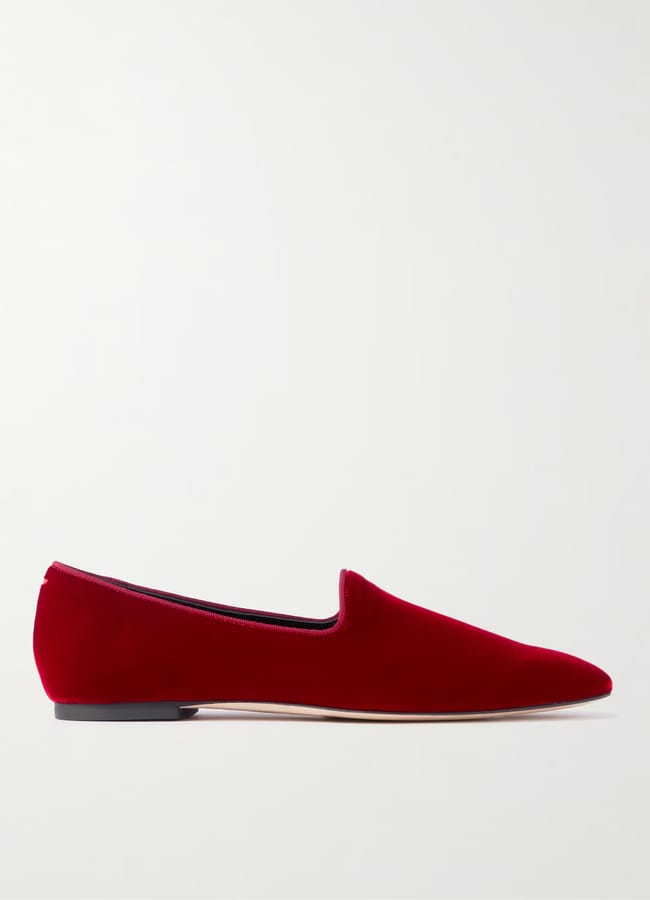 A single red velvet party wear loafer with a pointed toe and flat black sole, displayed in profile against a plain white background.
