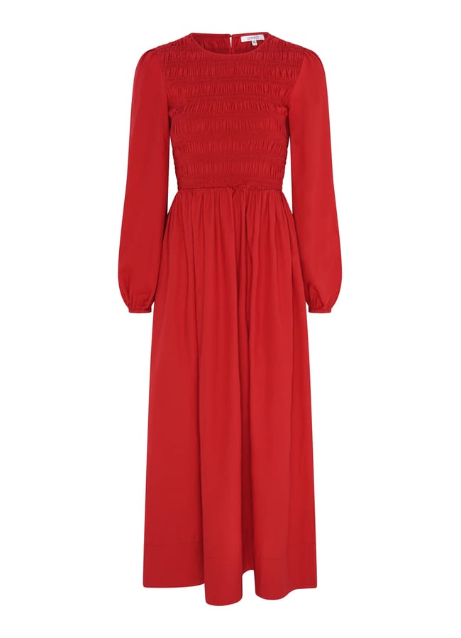 A long-sleeved, ankle-length red dress with a fitted, shirred bodice and a flowing skirt—perfect for complementing your Christmas tablescape—displayed on a plain white background.