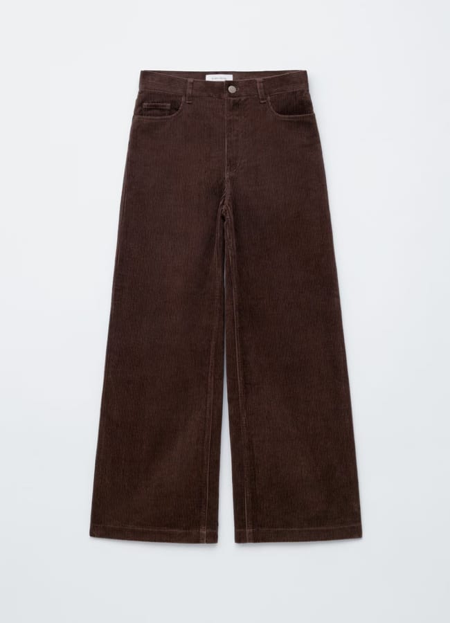 A pair of brown trousers, featuring wide-leg corduroy with front pockets, belt loops, and a button fastening, laid flat on a light background for a more chic look.