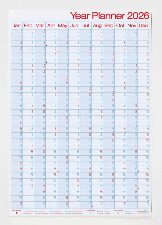A wall-mounted year planner for 2026, perfect for coordinating with your 2026 diaries, featuring months from January to December in rows and days in columns on a white background with blue and red text.