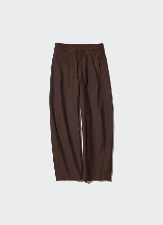 A pair of brown, straight-leg trousers with belt loops and side pockets, laid flat on a light grey background—perfect for chic outfits and staying ahead of fashion trends.