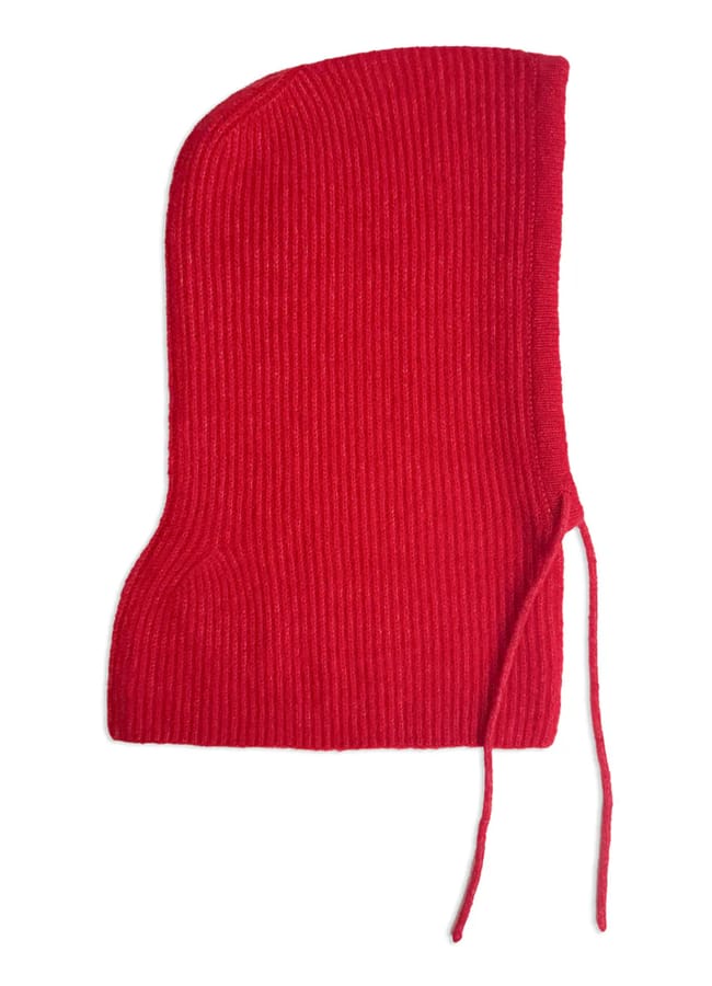 A red, ribbed knit balaclava with a rounded top and two hanging ties on one side, displayed flat against a white background—perfect for adding bold style to your collection of red accessories.