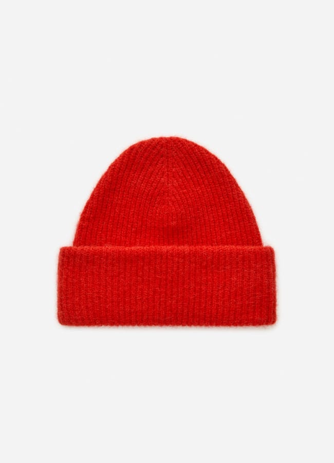 A bright red knitted beanie hat with a wide, folded cuff is showcased on a plain white background—a standout choice for those who love eye-catching red accessories.