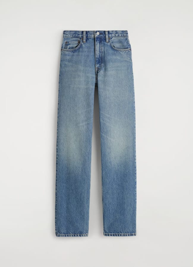 A pair of classic blue straight-leg jeans with a mid-rise waist, five pockets, and a slightly faded wash—perfect for casual outfits—displayed against a plain light background.