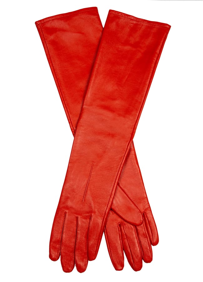 A pair of long, red leather gloves—perfect red accessories—laid flat and crossed over each other on a white background.