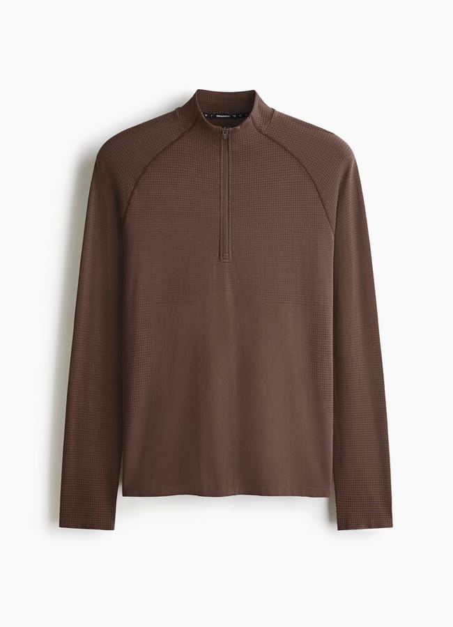 A long-sleeve, brown quarter-zip shirt with a subtle textured pattern, perfect as versatile gym clothes for men, displayed against a plain white background.