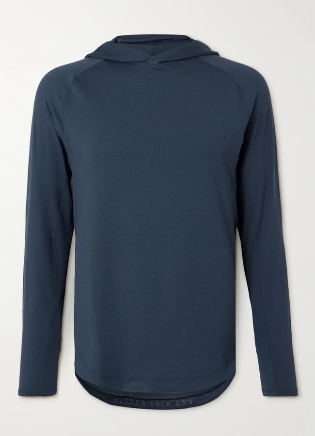 A dark blue, long-sleeve hooded top—ideal as gym clothes for men—is laid flat against a light background. The top features a simple, minimalist design with no visible patterns or logos.