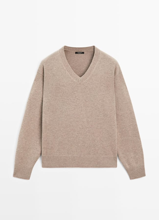Light brown, long-sleeve V-neck jumper made from a soft knitted fabric, perfect for women's workwear, laid flat on a white background.