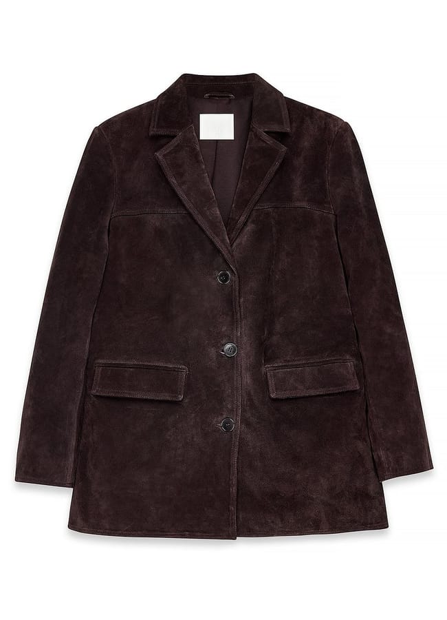 A dark brown suede blazer with a notched collar, two front buttons, and two flap pockets, styled alongside track trousers, laid flat on a white background.