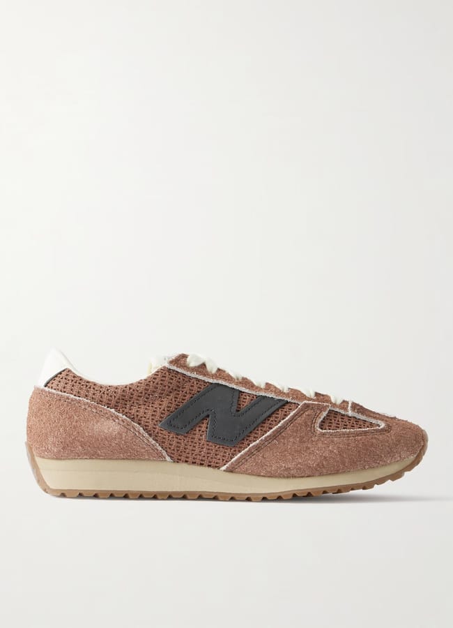 A brown trainer with a textured suede upper, black N logo on the side, white laces, white heel tab, and a beige rubber sole—perfect for pairing with casual outfits—shown in a side profile against a plain background.