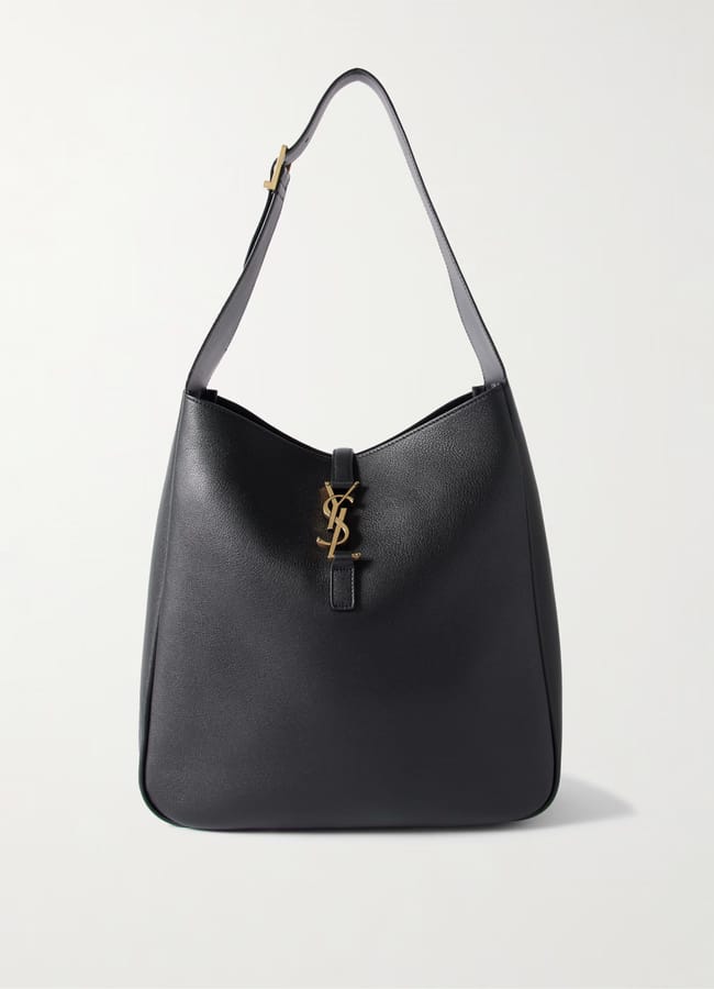 A black leather shoulder bag with a wide strap and gold YSL logo clasp on the front. Its minimalist, structured design and slight sheen make it a perfect accessory for elevating casual outfits.