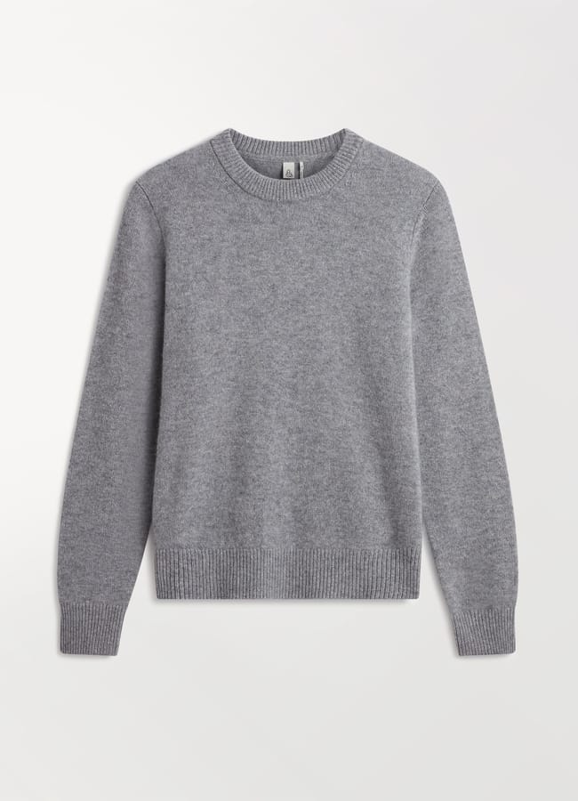 A plain light grey crewneck jumper with long sleeves, ribbed cuffs, hem, and neckline, displayed flat on a white background—perfect for layering in casual outfits.