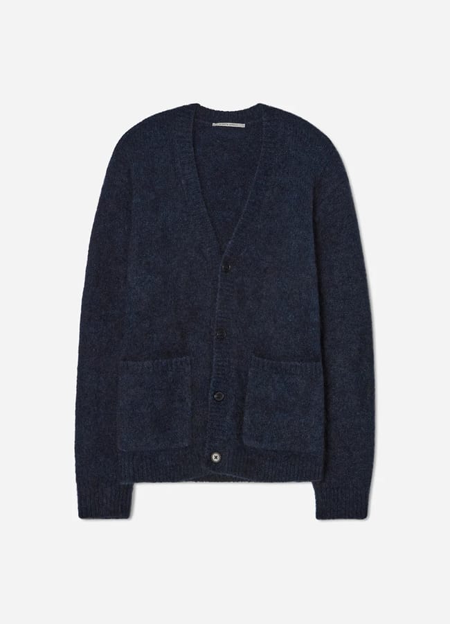 A dark blue, long-sleeve, button-up cardigan with two front pockets, perfect for casual date night looks, displayed flat on a white background.