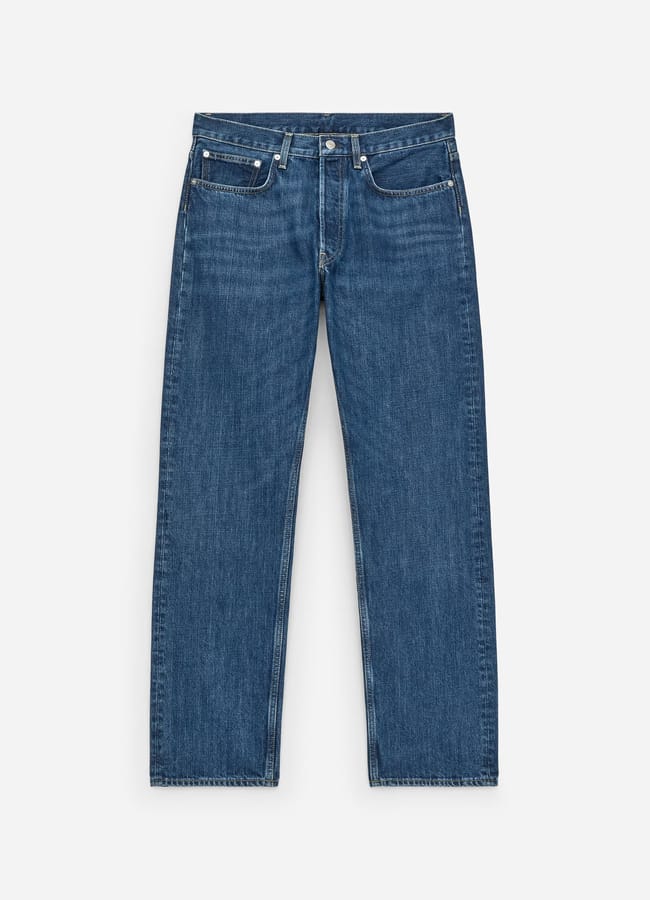 A pair of classic blue denim jeans with a straight-leg fit, five pockets, and button and zip fastening—perfect for casual date night looks—laid flat on a white background.