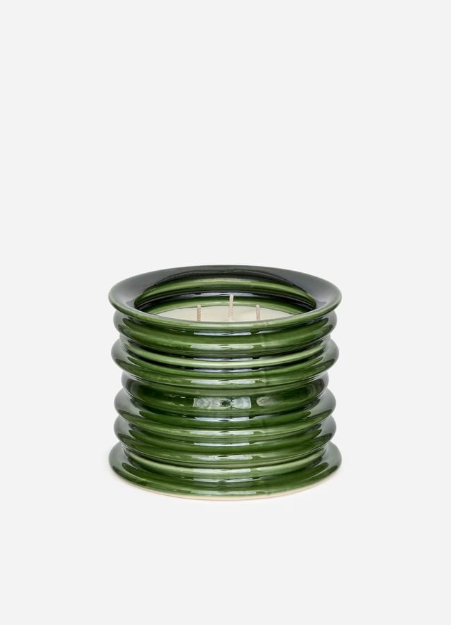 A round, green, ribbed glass candle holder with a glossy finish—perfect for high street homeware style—holds a white multi-wick candle and sits against a plain white background.