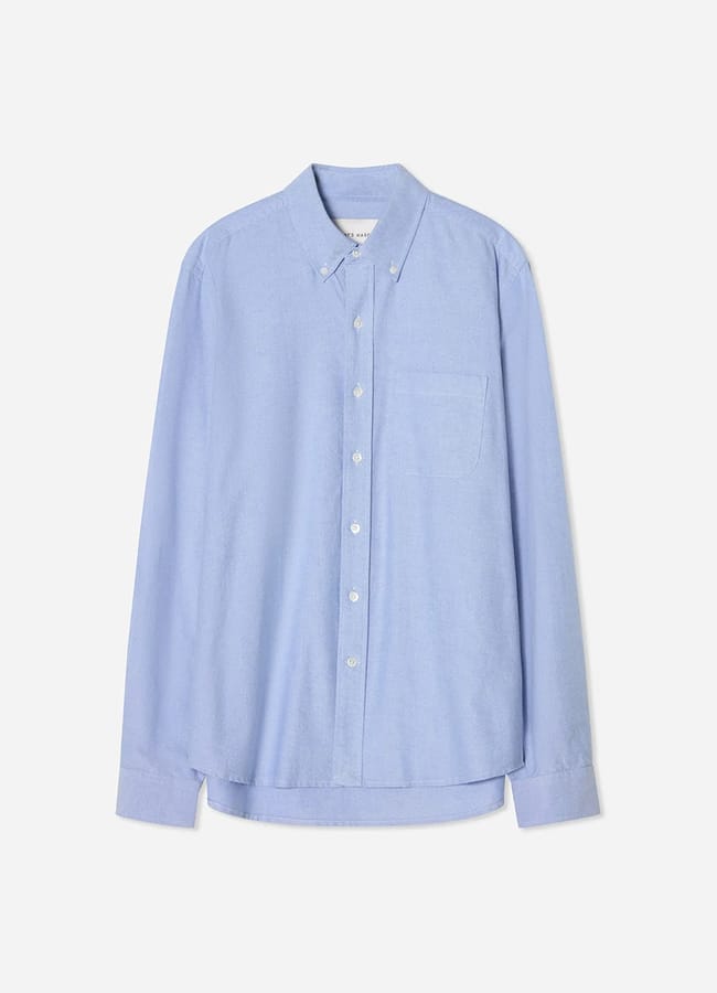 A light blue, long-sleeve button-up shirt with a front pocket and button-down collar, perfect for men's casual date night looks, laid flat against a white background.