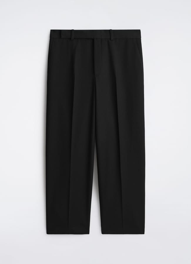 A pair of black, straight-leg dress trousers with belt loops and a front crease, laid flat on a white background—perfect for creating refined Casual Date Night Looks.