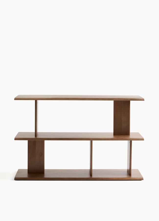 A modern, minimalist wooden bookcase with two shelves and vertical dividers, this high street homeware piece features a simple, open design against a plain white background.