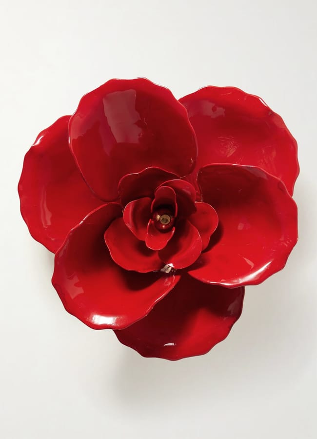A decorative bowl set shaped like a red flower with glossy petals arranged in layers, reminiscent of a fashion accessory, viewed from above on a white background.